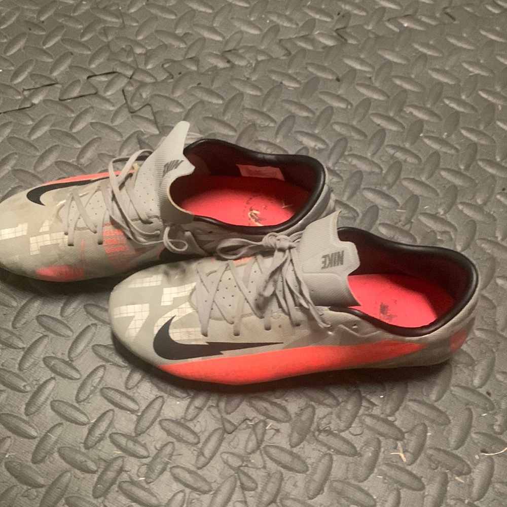 Grey and pink Nike mercurial cleats